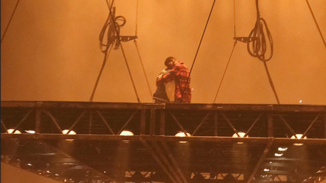Kanye and Kudi exchange hugs onstage before West's Sacramento show